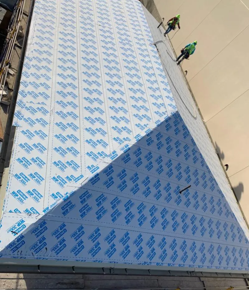 Professional roofers installing underlayment on a metal roof in Palmerton